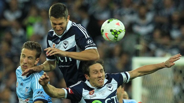 Marc Janko of Sydney FC, left, contests the ball with Carl Valeri and Mark Milligan.