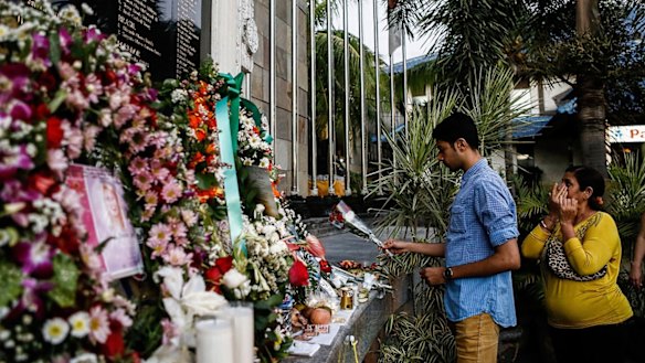 A man places flowers at the Bali Bombing Memorial Monument in Kuta, Bali, Indonesia in 2013.