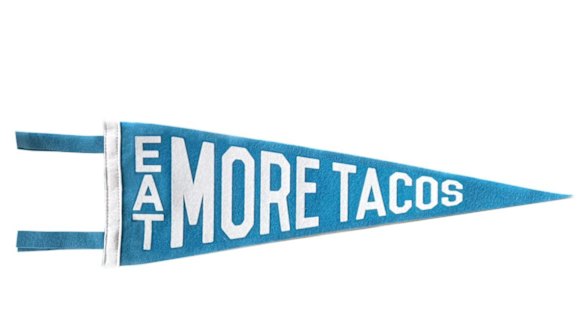 Eat More Tacos pennant, $US16 from Three Potato Four,
<a href="http://threepotatofour.com/collections/felt-pennants/products/eat-more-tacos-pennant-orange" target="_blank">threepotatofour.com</a>.