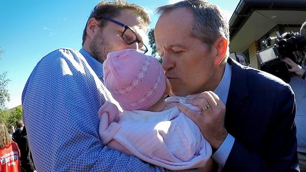 Opposition Leader Bill Shorten kisses a baby during the election campaign.