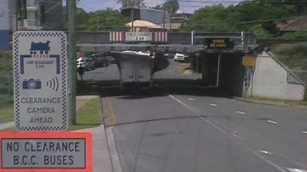 A truck smashes into the Allwood Street rail bridge in Indooroopilly.