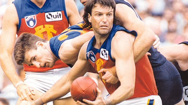 Fitzroy footballer Paul Roos fires off a handpass.