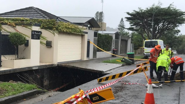 Road crews assess the damage after the footpath collapsed in Point Piper.