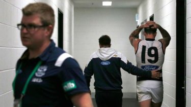 Mitch Clark is comforted by his coach, Chris Scott, after Geelong's win over Collingwood.