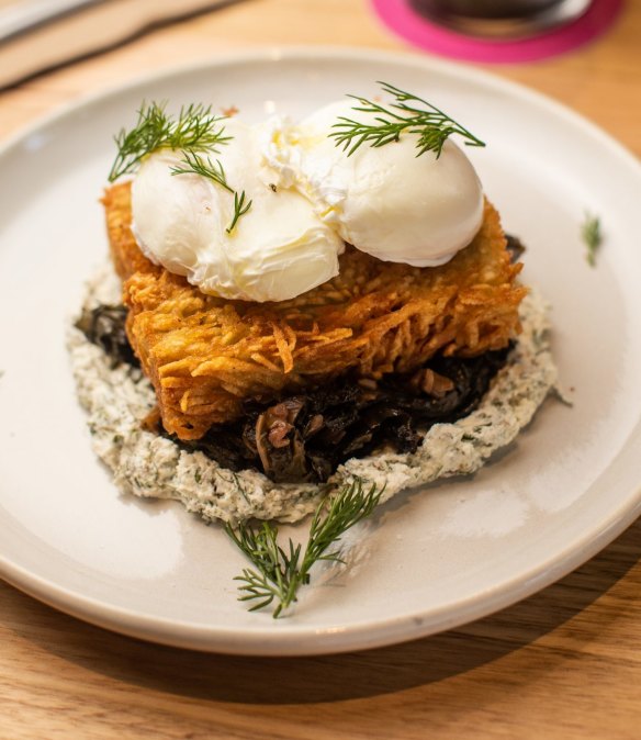 Poached eggs on potato rosti, goat's cheese and greens.