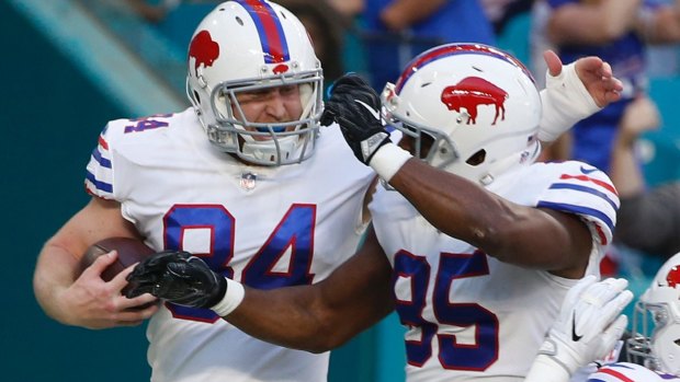 Buffalo Bills defensive tackle Kyle Williams (right) congratulates tight end Nick O'Leary (84), after O'Leary scored a touchdown.
