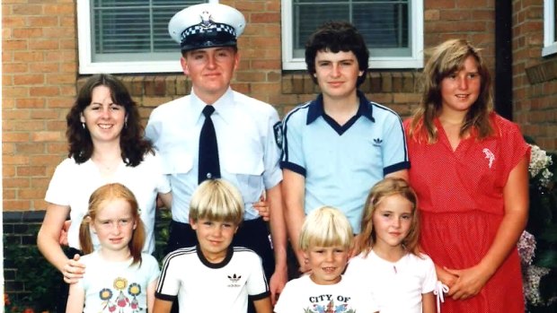 Ken Rich surrounded by his brother, sister and cousins on his graduation day from the police force.