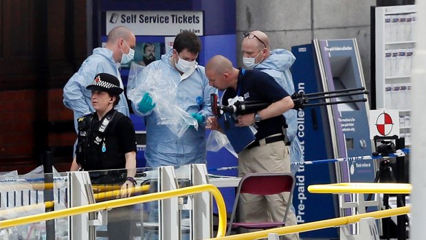 Forensic officers investigate the scene near Manchester Arena, where 22 people were killed.