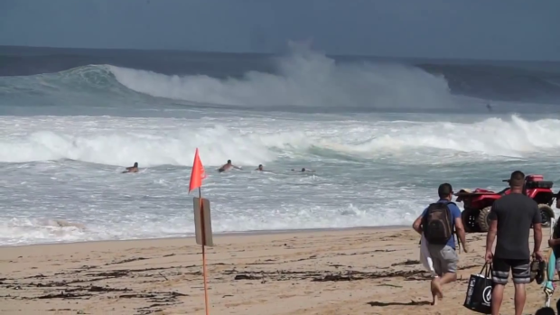 Rescuers, including Mick Fanning, rush to help the drowning surfer.