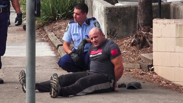 An unidentified man was handcuffed following the fatal shooting at Bankstown Central Shopping Centre, but was later released.