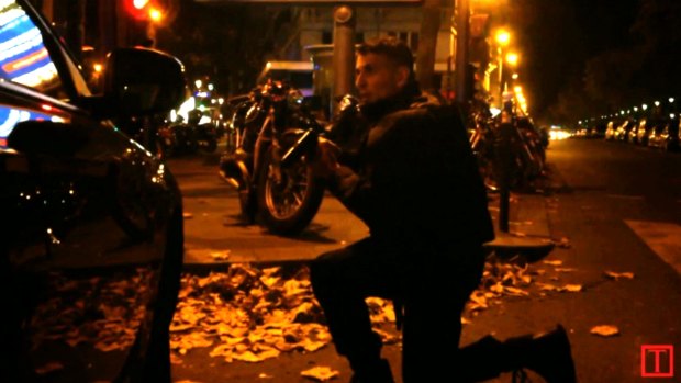 A policeman shelters during the gun battle.