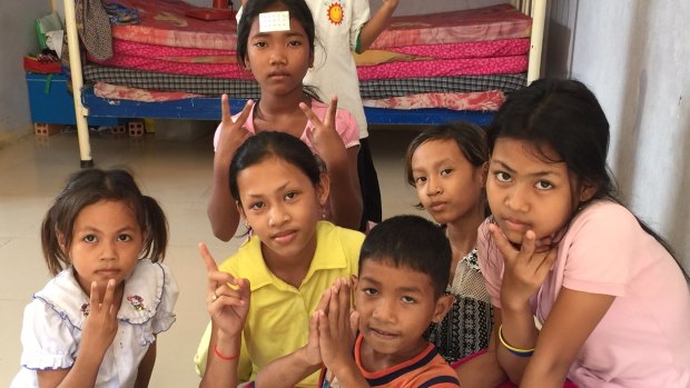 Children pose for photographs at a Phnom Penh orphanage in Decermber.

