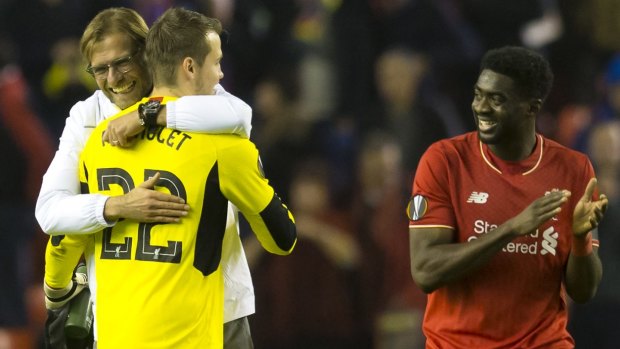 Liverpool's manager Juergen Klopp, left, celebrates with goalkeeper Simon Mignolet as Kolo Toure looks on after their team's 2-1 win against Bordeaux in the Europa League.