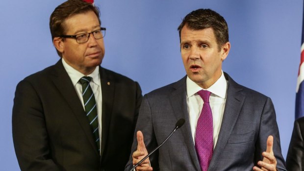 The greyhound ban is weighing heavily on Deputy Premier Troy Grant, left, and Premier Mike Baird. 