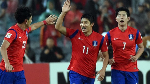 Lee Keun-Ho (second from left) celebrates with with teammates after scoring a goal.