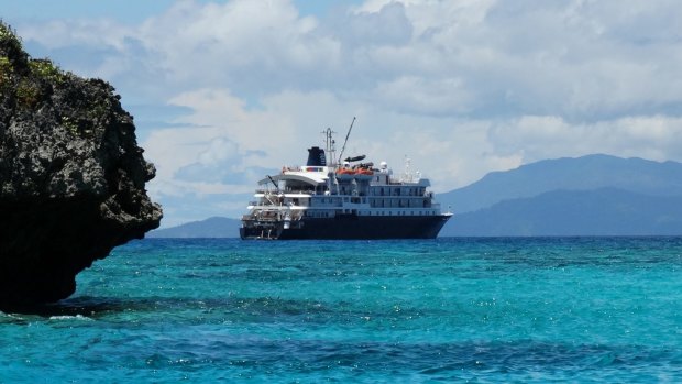 Luxury base: the Caledonian Sky, after a morning snorkelling among the atolls and coves of Pulau Wayag in West Papua.