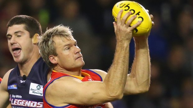 Richard Champion, left, of the All Stars marks Jonathan Brown of Victoria during an EJ Whitten Legends Game at Etihad Stadium in Melbourne last year. This year there is a bidding war between TV networks Nine and Seven for the rights to broadcast the 2016 Legends Game.  