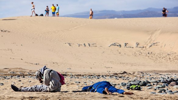 Two would-be immigrants rest at Maspalomas beach on Spain's Canary Islands.