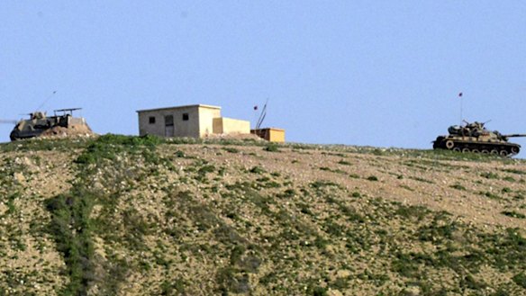 New position of the Suleyman Shah mausoleum is pictured from Turkish side of the border as Turkish army vehicles move inside Syria.