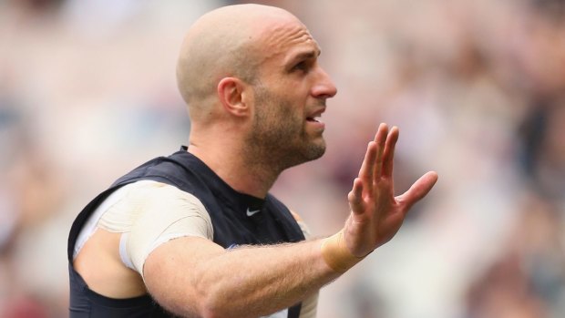 Chris Judd waved to the crowd as he was stretchered off the ground.