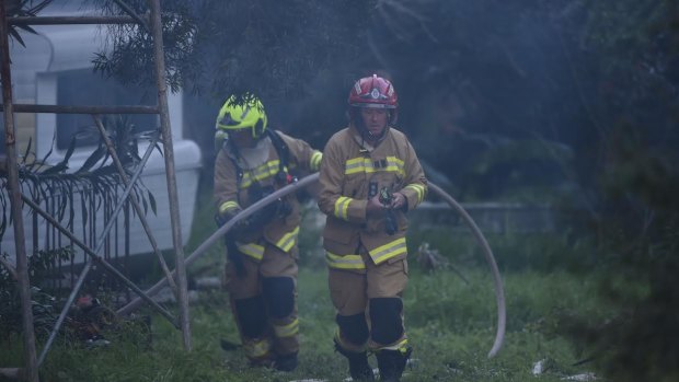 Firefighters were allegedly confronted by a man with an axe while battling a house fire in Whale Beach.