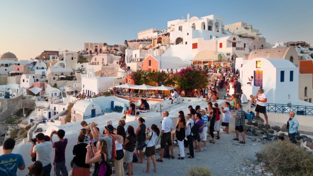 Tourists wait for the sunset at Oia, Santorini.