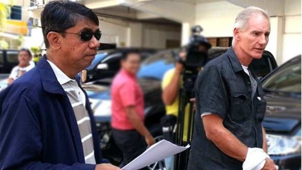 Peter Gerard Scully is escorted to court by agents of the Philippines National Bureau of Investigation before his incarceration at  Barangay Lumbia on Tuesday.