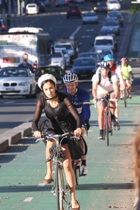 Safer passage: Cyclists ride along the bike lane on College Street.