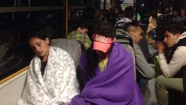 Migrants sleep on the bus as it leaves Hungary early on Saturday.