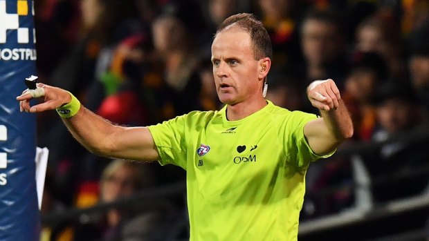 Charades: An umpire calls for a score review during round 14.