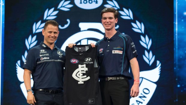 Paddy Dow of the Bendigo Pioneers (right) is presented with his guernsey by Carlton Blues coach Brendon Bolton after being selected as the No.3 draft pick during the first round of the 2017 AFL Draft.