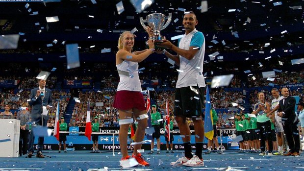 Daria Gavrilova and Nick Kyrgios of Australia Green pose with the Hopman Cup last week. Federer says Kyrgios' form needs to be matched by composure on and off the court.