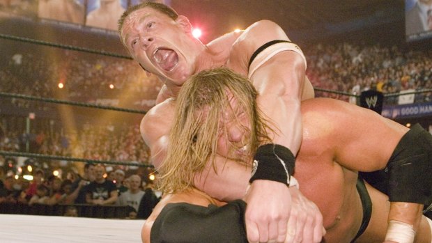 John Cena (top) wrestles Triple H at Wrestlemania 22. 