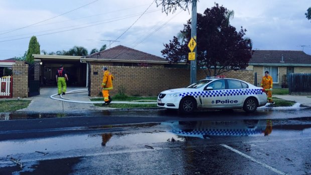 Firefighters drain the pool at  a Melton South house where a two-year-old drowned on Monday. 