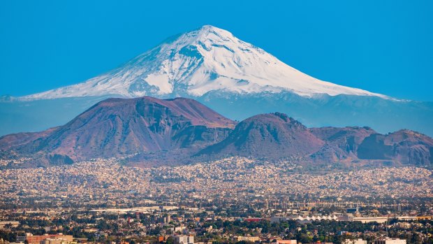 View of the snow covered Popocatepetl volcano as seen from Mexico City.
