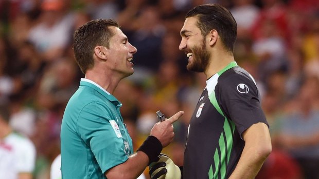 No laughing matter: Ben Williams shares a joke with Iran goalkeeper Ali Reza Haghighi.