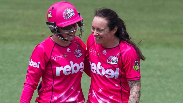 Welcome back: Alyssa Healy and the returning Sarah Coyte celebrate the wicket of Suzie Bates.