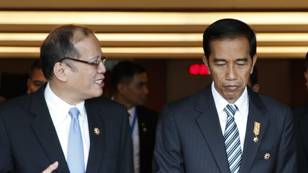 Philippine's President Benigno Aquino III, front left, and Indonesia's President Joko Widodo, front right, chat after the plenary session of the 26th ASEAN Summit in Kuala Lumpur, Malaysia, on Monday, April 27, 2015. (AP Photo/Joshua Paul)