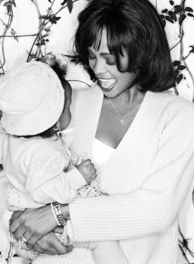 Whitney Houston holding a baby Bobbi.