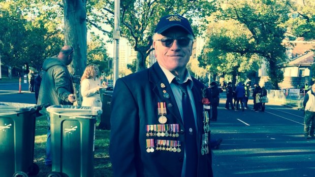 Malcolm Fudge wears his family's medals on on the right side of his blazer and his own on the left.