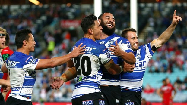 1985 Entertainers revisited? Bulldogs players celebrate the try of Sam Kasiano against St George Illawarra on Monday.