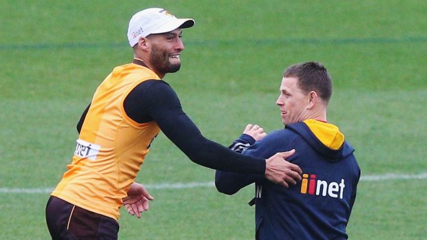 Josh Gibson playfully grabs former Hawks assistant coach Brendon Bolton at training on Tuesday.