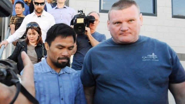 Manny Pacquiao with promoter Deano Lonergan (right) leave a church in Carina at the weekend.