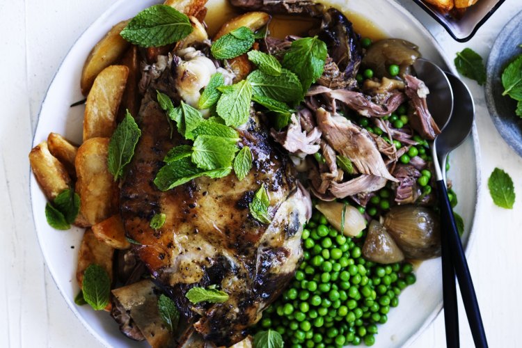 Slow-roasted lamb with tarragon, peas and crispy potatoes.