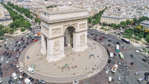 Around the Arc de Triomphe in Paris you give way to cars coming into the roundabout, rather than the cars already on it. 