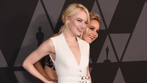 Emma Stone (being photobombed by Jennifer Lawrence).