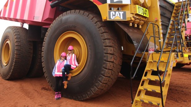 Gina Rinehart and daughter Ginia on a pink mining truck at the Roy Hill iron ore mine.