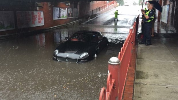 A Maserati stuck in floodwater during the storms in Melbourne.