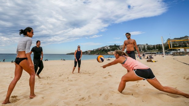 Coogee Beach visitors enjoy the hot weather on Sunday.