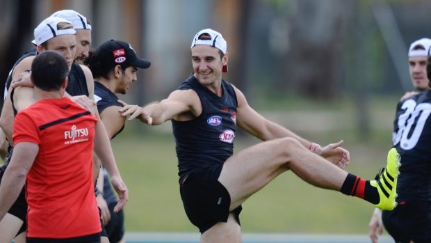 Happy returns: Watson limbers up with other Bombers returning from the ban.